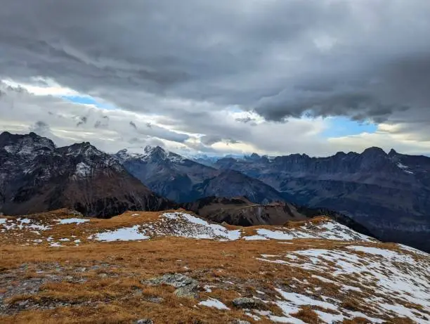 beautiful autumn hike in the beautiful swiss mountains Panorama picture with the first snow.Mountain peaks full of snow