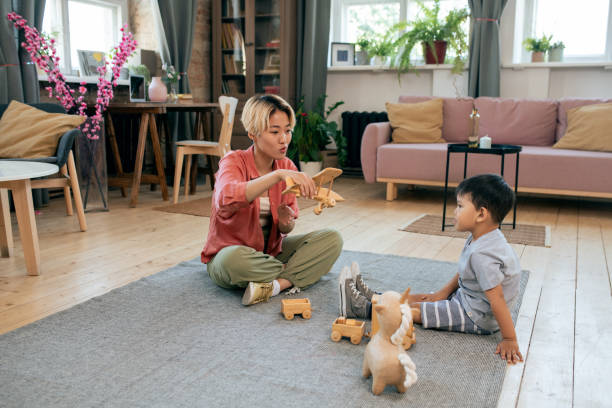 istock Young Asian female playing with her cute little son 1358407955