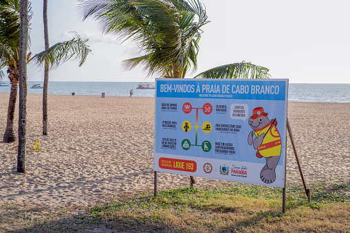 João Pessoa, Paraíba, Brazil - October 18, 2021:Informational and educational board on the sand of the beach