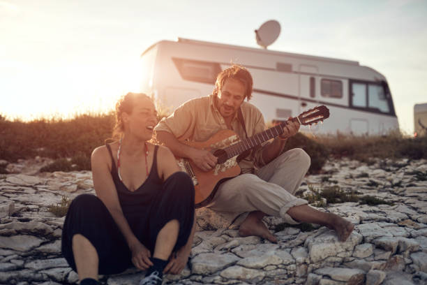 istock Man singing to his girlfriend on a beach. 1358415326