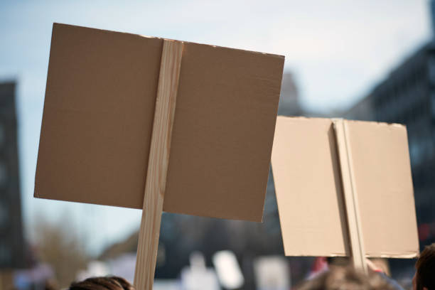 istock Protesters holding placards and signs on the streets. 1358415938