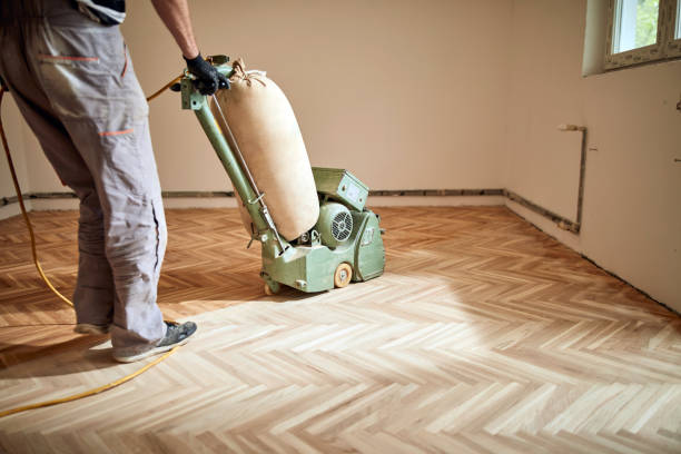 istock Repairman restoring parquet with a sanding machine. 1358416023