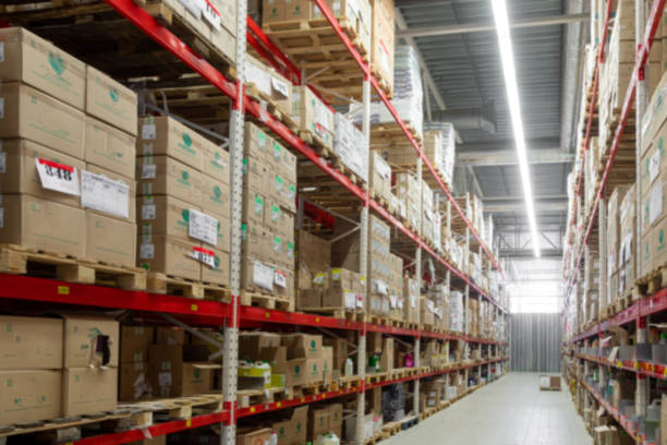 istock warehouse in the logistics center with boxes ready for shipment, blurred photography, defocus 1358416065