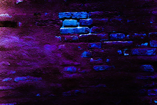 Brick neon wall. Dark blue night light. Abstract bar neon texture. Celebratory night view, neon light, rays background