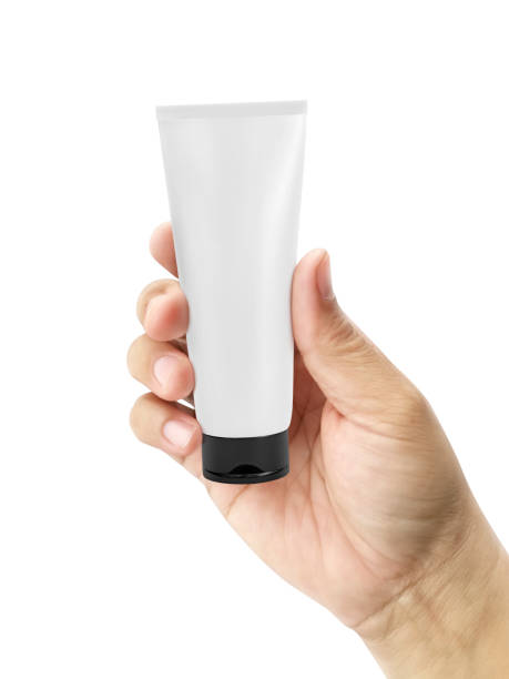 istock Hand holding Cosmetic plastic tube isolated on white background 1358419064