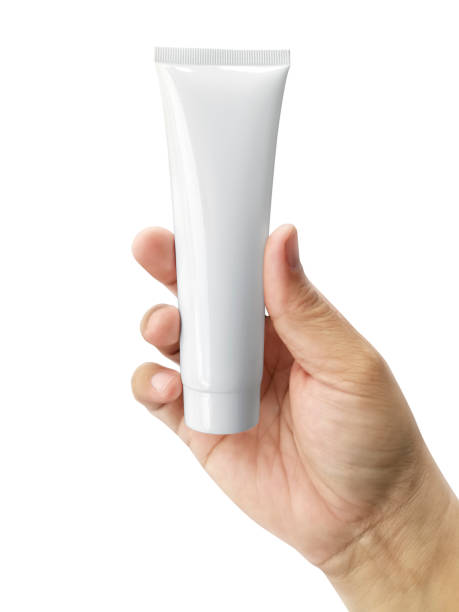 istock Hand holding Cosmetic plastic tube isolated on white background 1358419162