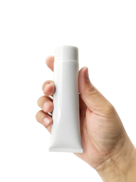 istock Hand holding Cosmetic plastic tube isolated on white background 1358419196