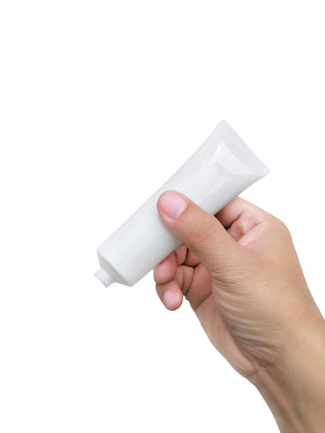 istock Hand holding Cosmetic plastic tube isolated on white background 1358420152
