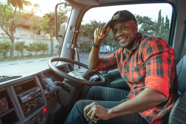 happy Smile Confidence Young Man Truck Driver In Business Long transport. Smile Confidence Young Man Professional Truck Driver In Business Long transport. Portrait young man African American Trucking, Service, Transport and Delivery business owner driving happy at warehouse driver occupation stock pictures, royalty-free photos & images