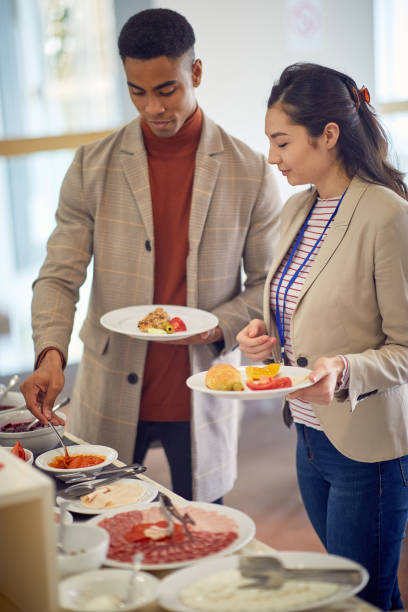 istock multiethnic colleagues having lunch at office cafeteria 1358425302