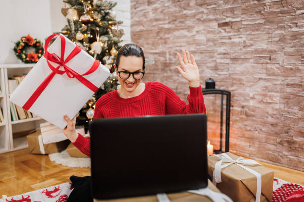 istock A young woman wants to open a gift 1358426340