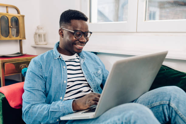 istock Young African-American working from his sofa 1358429623