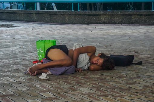 Taipei, Taiwan - June 4, 2019: Homeless man sleeps on city street