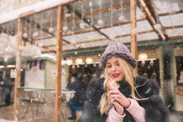 istock Amazing lady wears knitted cap holding yummy ginger cookie 1358438437