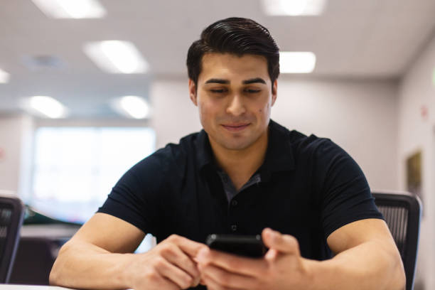 istock Using Technology Mexican American Male in Business Retail Center Working Together LatinX Candidates Photo Series 1358438708