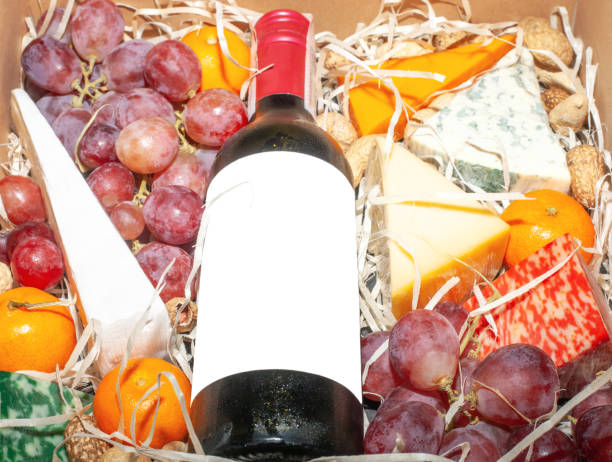 gift box with lying red wine and fruit closeup. wine bottle mockup and food in basket - close to food and drink yummy food imagens e fotografias de stock