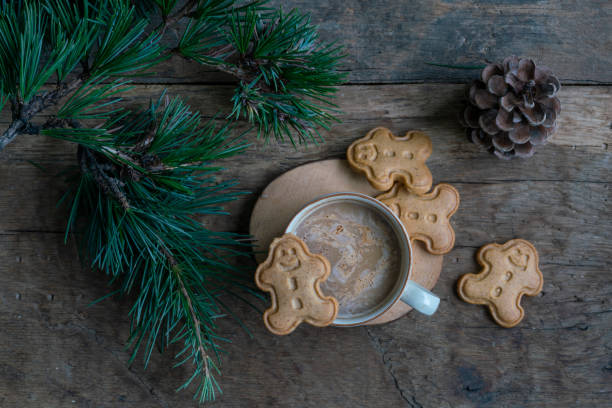 istock coffee and gingerbread noel cookies on wooden table with pine tree branches for christmas 1358442408