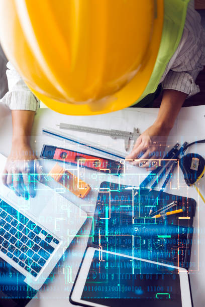 engineer working at a drawings of house in office for discussing. Engineering tools and construction concept.