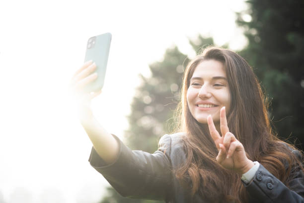 istock Young beautiful girl taking selfie 1358450530