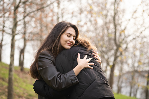 Two best friends hug for support.