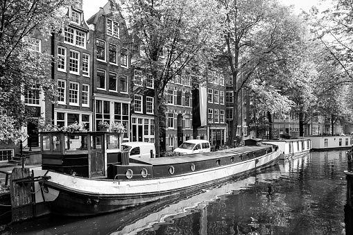 Canal in Amsterdam with houseboats. Black and white cityscape.  Netherlands