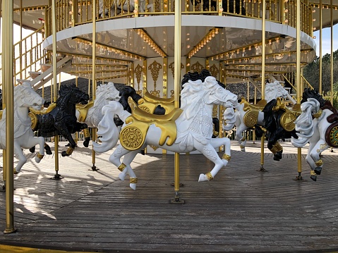 Part of popular vintage, retro carousel (merry-go-round) by the Eiffel Tower in Paris on sky sunset background. France. Copy space. Empty space for your message.