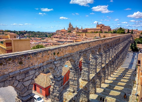 The famous ancient aqueduct of Segovia with the cathedral in the background, Castilla y León, Spain