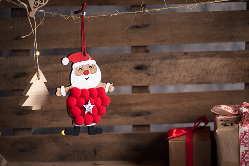 Wooden Christmas Santa Claus decoration on a rustic wooden background, stock photo