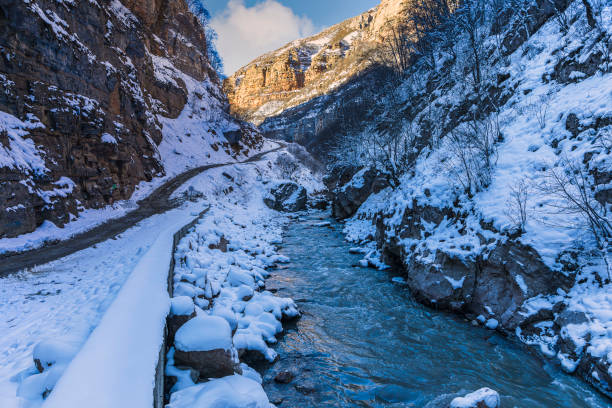 Mountain river flowing in the gorge in winter
