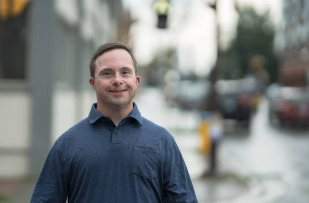 istock Man with down Syndrome Walking Outside 1358458906