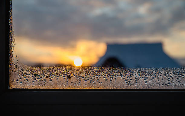 Condensation water drops on home windows in the morning in winter. High humidity level concept. Condensation water drops on home windows in the morning in winter. High humidity level concept. humidity stock pictures, royalty-free photos & images