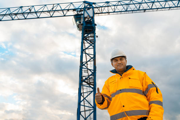 istock Portrait of engineer looking at camera inside construction site 1358462166