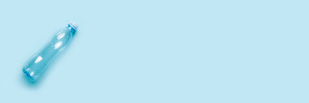 istock empty plastic bottle on a blue background. Top view, flat lay. Banner 1358465784