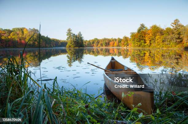 Canoe With Paddle On Shore Of Beautiful Lake With Island In Northern Minnesota At Dawn Stock Photo - Download Image Now
