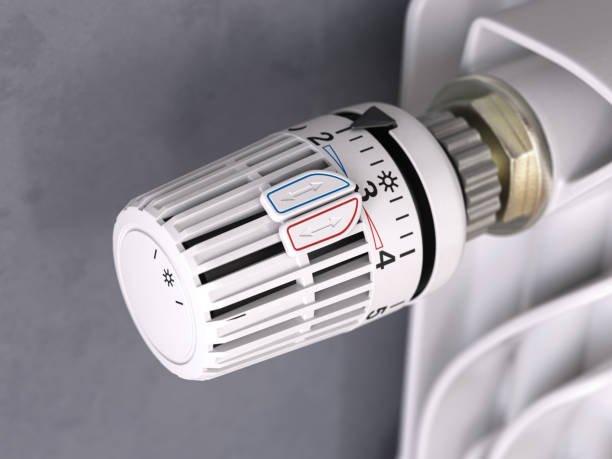 istock Thermostatic radiator valve close up. Temperature control and consumption saving 1358471379