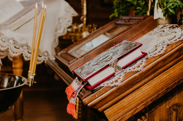 rite of sacrament of epiphany in church. lighted candles near bible altar rite of sacrament of epiphany in church. lighted candles near bible on altar pics of the godmother stock pictures, royalty-free photos & images