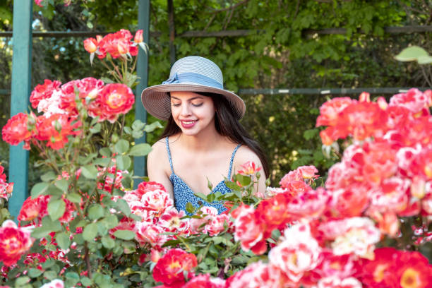 istock Young woman portrait using a hat at park 1358473124