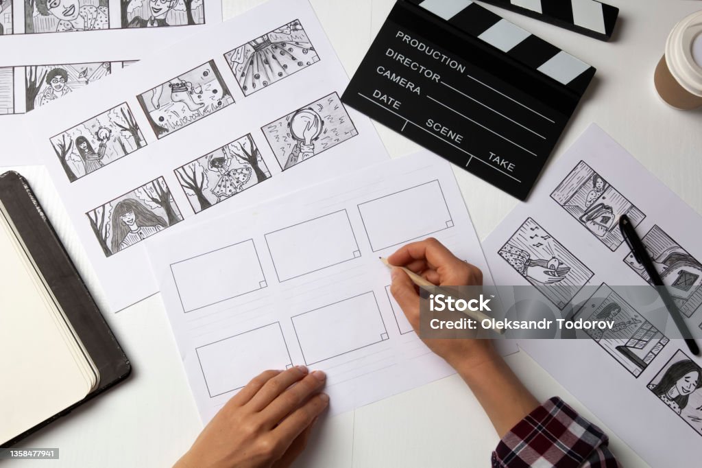 The artist draws a storyboard for the film. The director creates the storytelling by sketching footage of the script on paper. Cartoon Stock Photo