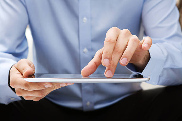 istock Young adult working on a digital tablet 135847869