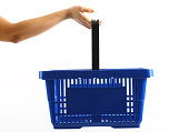 A woman holding a blue shopping basket