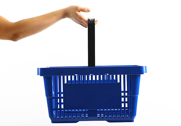 A woman holding a blue shopping basket Shopping basket holding shopping basket stock pictures, royalty-free photos & images