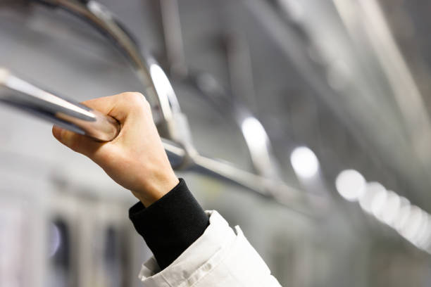 istock Passanger holding handrail in subway train 1358489046