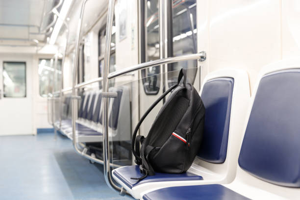 istock Forgotten black backpack or bomb on a seat in subway train, public transport. 1358489047