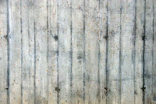 Old concrete wall texture with nail holes