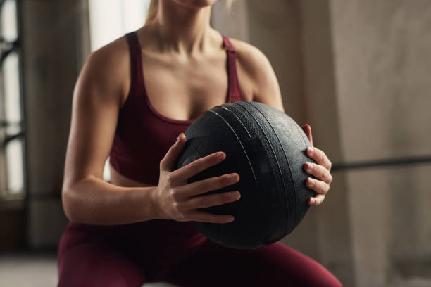istock Crop sportswoman squatting in gym 1358492314