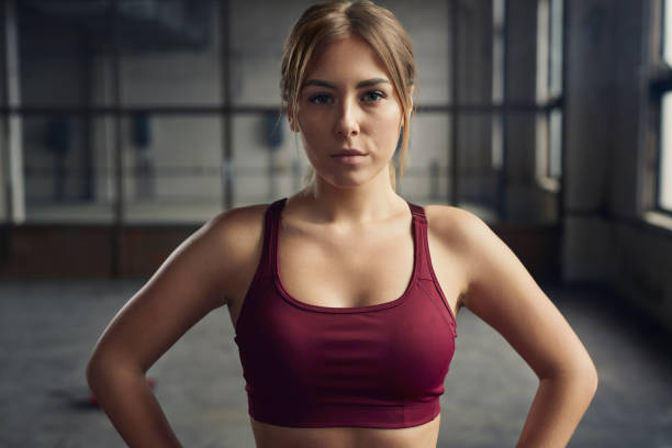 istock Confident sportswoman during training in gym 1358492324