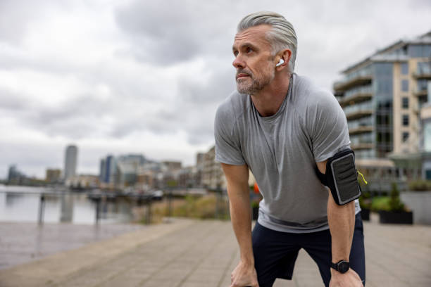 istock Man taking a brake while running outdoors 1358492913