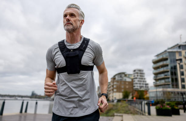 istock Athletic adult man jogging outdoors wearing a vest 1358492923