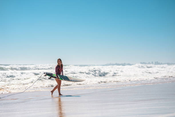 istock Young Gold Coast Female Surfer Running at Water’s Edge 1358493674