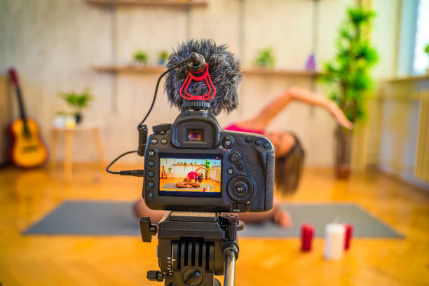 istock Woman recording herself while doing yoga 1358493964